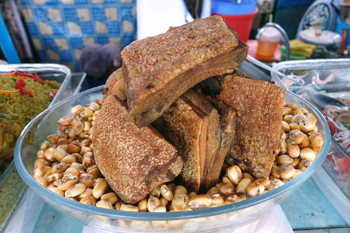 Chicharrón in a bowl that is also filled with deep fried corn.