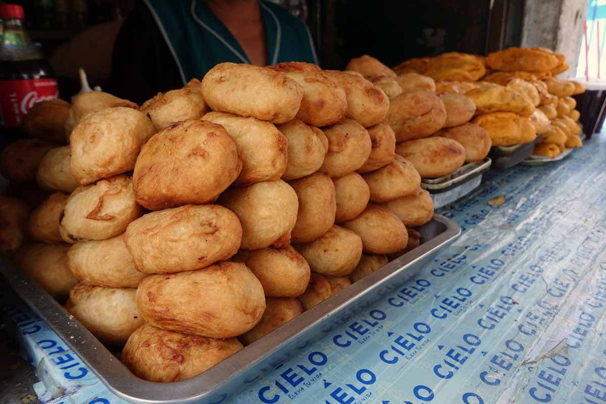 A tray piled with what looks like baked potatoes. But they are actually hand molded mashed potatoes deep fried to a crispy golden color.