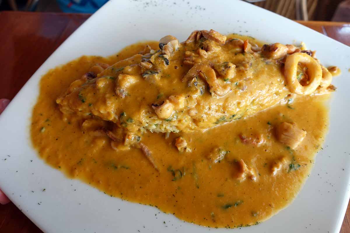 tacu tacu - a fritter-like concoction smothered in a yellow seafood sauce.